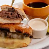 French Dip Hot Roast Beef · Slow roasted roast beef served on a torpedo roll with melted white cheddar. Au jus on the si...