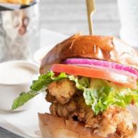 Fried Chicken Sandwich · zesty seasoned fried chicken breast topped with house made hot sauce + ranch, served on brio...