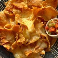 Kids Nachos · small portion of cheese nachos with salsa on the side.