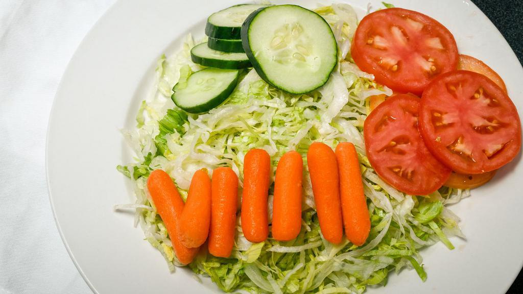 House Salad · Salad greens topped with chopped cucumbers & tomatoes, and baby petite carrots.