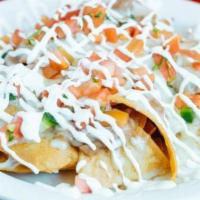 Nachos Grande · Home-made crispy corn tortilla chips pilled with beans and melted cheese, topped with sour c...