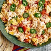 Huevos A La Mexicana · Scrambled eggs with tomato, onions, and jalapeños. Served with Mexican rice, beans, and corn...