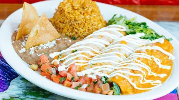 Enchiladas · Corn tortillas stuffed with your choice of meat smothered with your choice of sauce and melted cheese. Topped with sour cream and served with Mexican rice and beans.