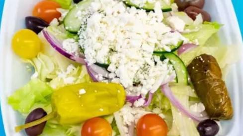 Greek Salad · Lettuce, tomatoes, cucumbers, red onions, feta cheese, kalamata olives, dolmades  and pepperoncini with house balsamic  vinaigrette