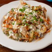 Chicken Shawarma Poutine  · chicken shawarma served over french fries with feta cheese and tahini sauce