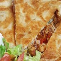 Spicy Chicken Quesadilla · Grilled chicken, mozzarella cheese, peppers, onions  and habanero sauce, served with a side ...