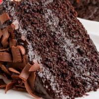 Chocolate Cake · Chocolate lovers dessert. Served with chocolate bliss in layers of moist chocolate cake.