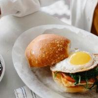 Halloumi & Sunny-Side Breakfast Sandwich · Seared halloumi cheese, griddled tomatoes, and sautéed spinach with a sunny-side up egg on o...