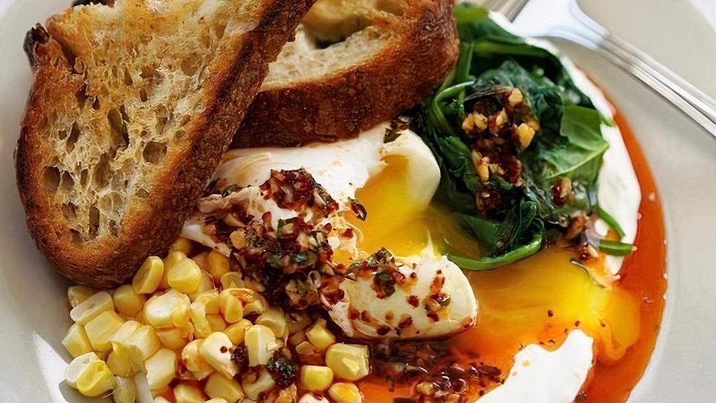 Spinach, Corn & Egg Plate · Sauteed spinach, fresh corn, and poached egg served over garlic labneh and topped with Aleppo chili oil. Served with housemade sourdough.. Contains: Wheat, Dairy, Egg