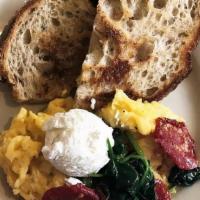 Tomato & Goat Cheese Scrambled Egg Plate · Two eggs soft scrambled served with ricotta goat cheese mousse and sun-dried cherry tomatoes...