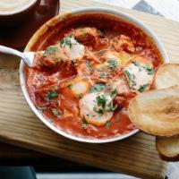 Traditional Shakshuka · Traditional North African dish of eggs poached in a tomato sauce with chili, bell peppers, a...
