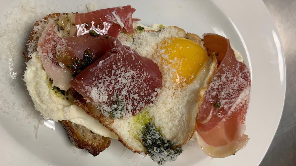 Prosciutto & Fried Egg Tartine · Prosciutto, housemade pesto, sunny-side . up egg, grated parmesan on a whipped goat and ricotta cheese, served on housemade sourdough.. Contains: Wheat, Dairy, Egg, Tree Nut (Pine)