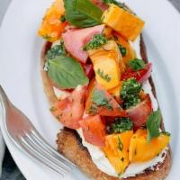 Heirloom Tomato Tartine · Heirloom tomatoes tossed with garlic olive oil and basil served over goat cheese mousse and ...