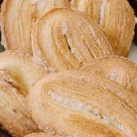 Palmier · Flaky puff pastry dough sliced thin, baked with sugar and shaped like a 