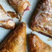 Roasted Strawberry Turnover · Flaky puff pastry filled with roasted strawberries.. Contains: Wheat, Dairy, Egg