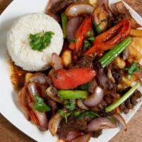 Lomo Saltado · Chunks of beef sauteed with onions, tomatoes, green and red peppers served over French Fries...