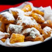 Fried Dough Bites · With cinnamon & powdered sugar with caramel drizzled on top.