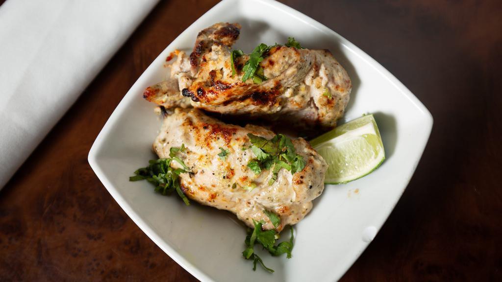 Murg Malai Kebab · Murg malai kababs are irresistible tender succulent and fragrant pieces of chicken that melts in mouth as they are marinated in thick yogurt, cream and malai, cheese, saffron, herbs, and spices which adds an nice creaminess to the kebabs. Served with grated salad and mint chutney.