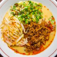 Takkii Beef Ramen · Spicy. Rich shoyu (soy) broth, signature chili oil, marinated shaved beef, caramelized  onio...