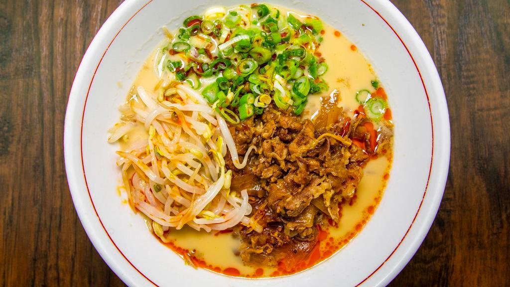 Takkii Beef Ramen · Spicy. Rich shoyu (soy) broth, signature chili oil, marinated shaved beef, caramelized  onions, scallions, bean sprouts.