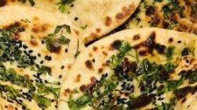 Paneer Stuffed Naan · Traditional Indian flatbread stuffed with freshly grated paneer (Indian cheese), coriander, onion, cumin and spices.