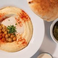 Hummus Plate & Pita · Creamy home-made hummus base with tahini and chickpeas, served with your choice of protein, ...