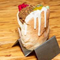 In A Pita Classic Falafel · Our Award Winning fresh baked pita filled with chickpea zucchini falafel, green salad, tahin...