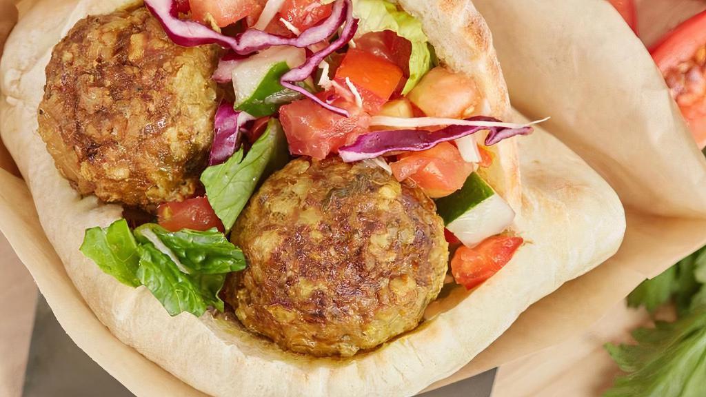 In A Pita Angus Beef Meatballs · Our Award Winning fresh baked pita filled with slow cooked Angus beef meatballs, green salad, tahini sauce and traditional hummus.