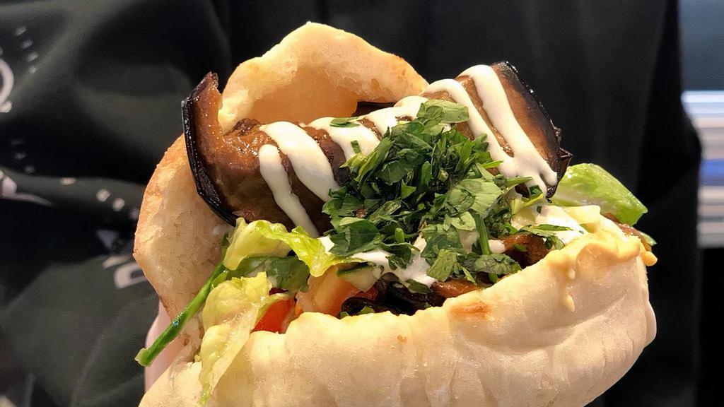In A Pita Roasted Eggplant & Hard Boiled Egg ('Sabich') · Our Award Winning fresh baked pita with roasted eggplant & hard boiled eggs, green salad, tahini sauce and traditional hummus.