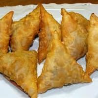 Veggie Sambusa · A deep fried pastry triangle filled with savory spiced and baked lentils.