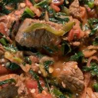 Lamb Tibs · Cubes of lamb loins simmered with onions and peppers in Ethiopian butter and spices.