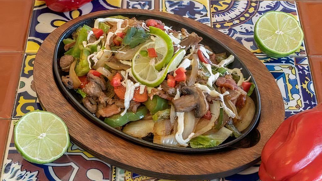 Alambre Mexicano · Steak, bacon, mushrooms, green peppers, jalapenos, and onions. Covered with Oaxaca cheese and special cheese. Served with rice and beans.