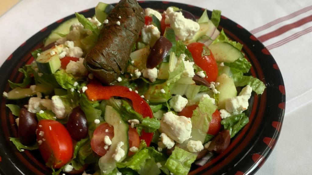 Mediterraean Salad · Romain hearts, olives, red peppers, cucumbers, tomatoes, grape leaves, feta, lemon-oil vinaigrette.