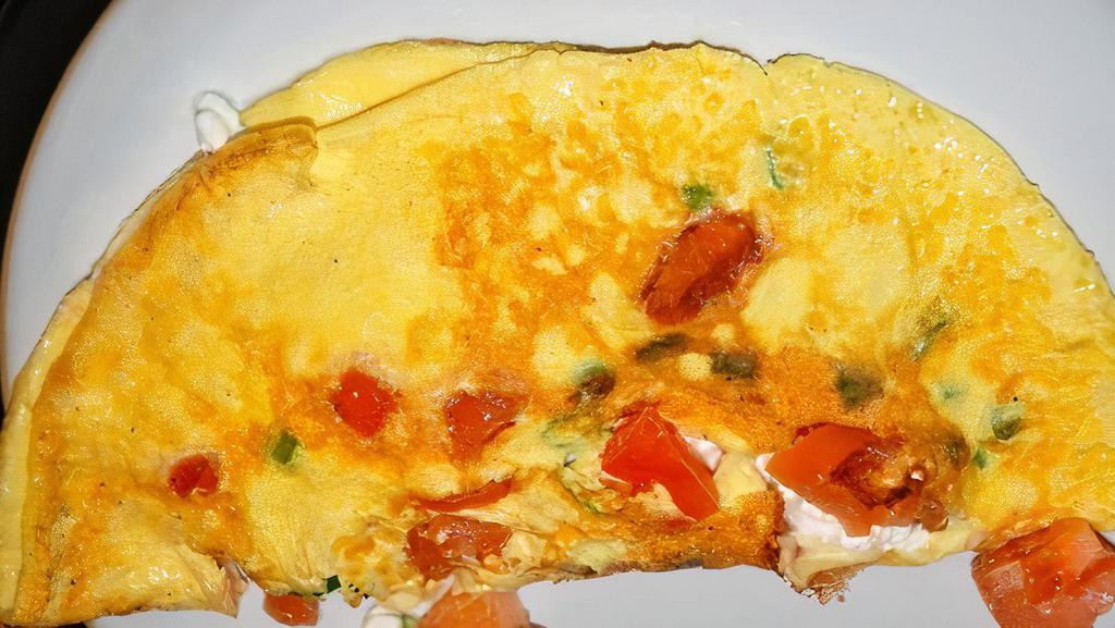Tomato Omelette Breakfast · Made with three large fresh eggs. Served with homefries.