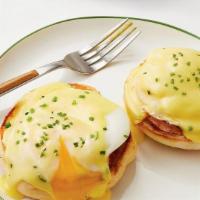 Eggs Benedict Breakfast · Two poached eggs on top of Canadian bacon and toasted muffin, then topped with hollandaise s...