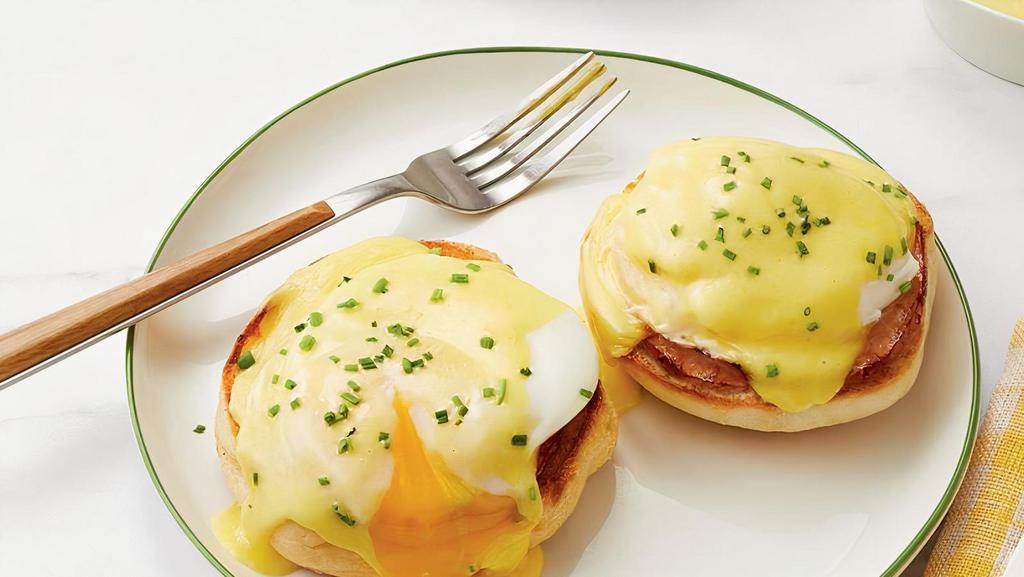 Eggs Benedict Breakfast · Two poached eggs on top of Canadian bacon and toasted muffin, then topped with hollandaise sauce.