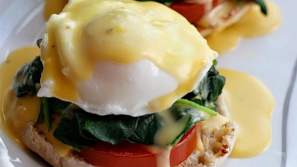 Florentine Benedict Breakfast · Two poached eggs on top of sauteed spinach, grilled tomatoes and toasted English muffin, then topped with hollandaise sauce.