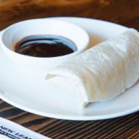 Peking Duck Rolls · Chinese roasted crispy duck meat and skin served with scallion, cucumber and house sauce in ...