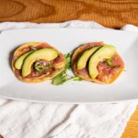 Tuna Tostadas · tuna tartare mexican style on toasted tortillas, serrano peppers, red onions, fried leeks, a...