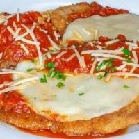 Chicken Parmigiana · Breaded cutlet topped with fresh tomato sauce & baked with mozzarella cheese served with sid...