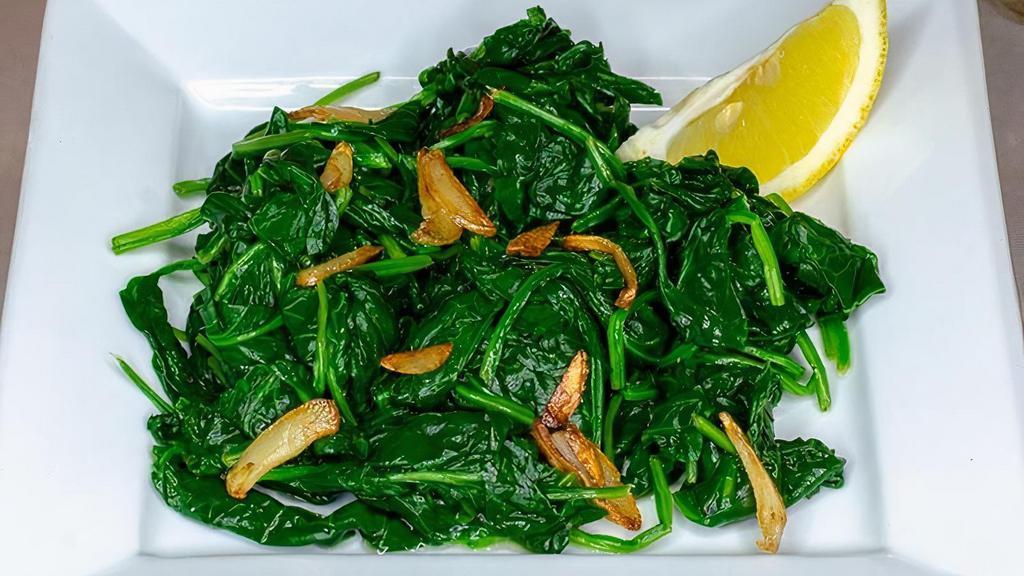 Side Spinach · Sautéed baby spinach with olive oil & garlic, served with fresh lemon