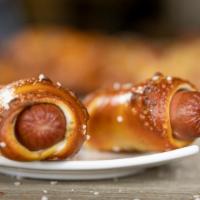 Hot Dog · Beef Hot dog wrapped in pretzel dough with salt.