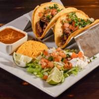 Steak Taco · Three tacos filled with marinated steak.
