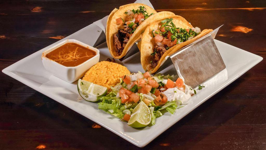 Steak Taco · Three tacos filled with marinated steak.