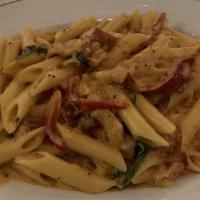 Penne Con Vodka Dinner · Penne swirled in a sauce of cream, prosciutto, roasted red peppers, plum tomatoes, basil, on...