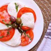 Caprese Salad · Made of sliced fresh mozzarella, tomatoes, and sweet basil, seasoned with salt and olive oil.