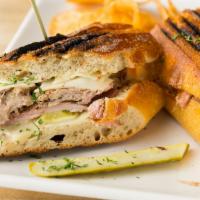 Cubano · Smoked pulled pork, Virginia ham, Swiss cheese, dill pickles and mustard sauce pressed on a ...