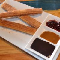 Cinnamon Churros · Spicy Mexican chocolate, dulce de leche and raspberry dipping sauces.