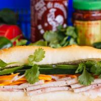 Banh Mi Classic Pork · Home-made spread, pickled daikon, carrot, cucumber, cilantro, jalapeño and black pepper.