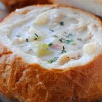 Clam Chowder In A Bread Bowl · New England Clam Chowder accompanied by a Peasant Bread Boule'. Just reheat and pour into th...